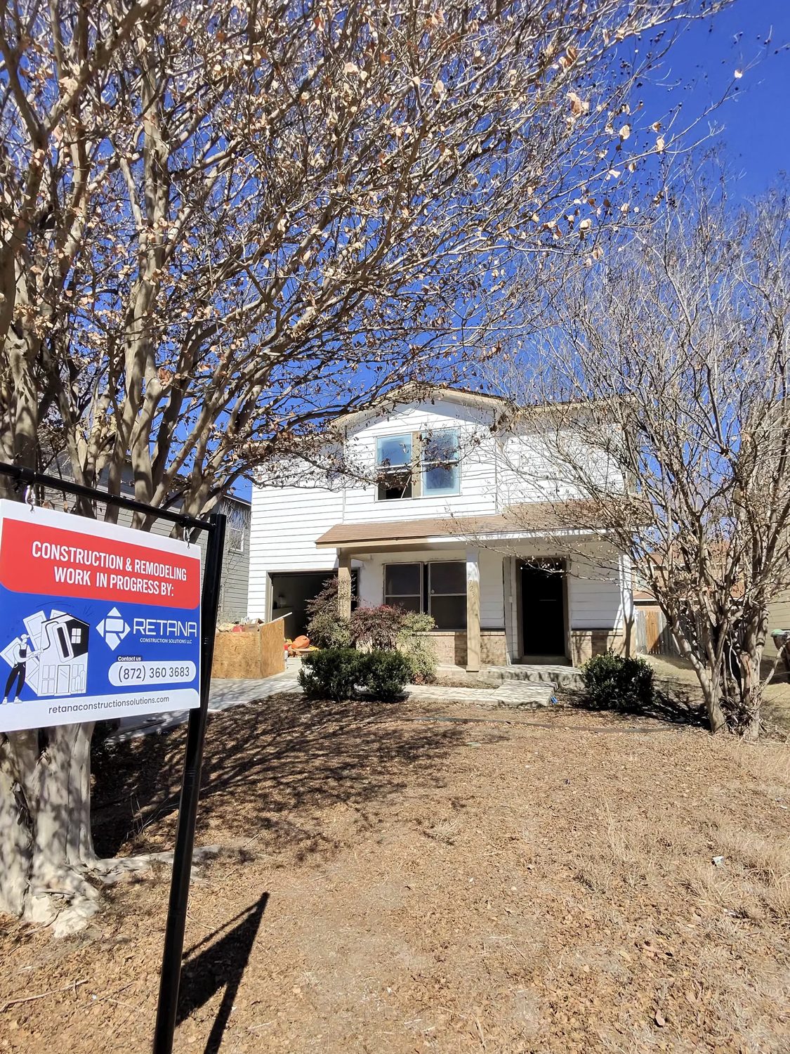 Exterior during construction with the Retana Construction Solutions sign